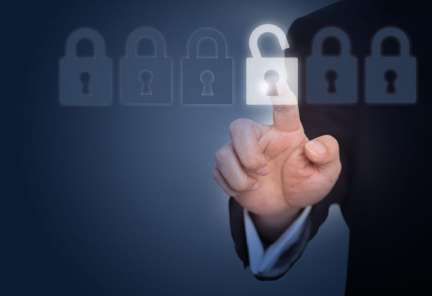 businessman unlocking a lock on the touch screen