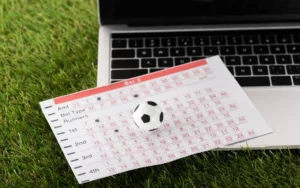 notebook e bola de futebol apostas esportivas